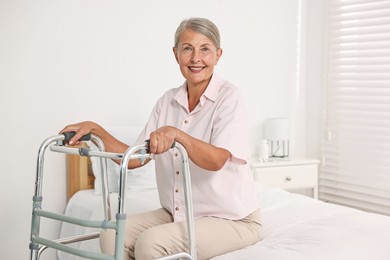 Photo of Senior woman with walking frame in hospital ward