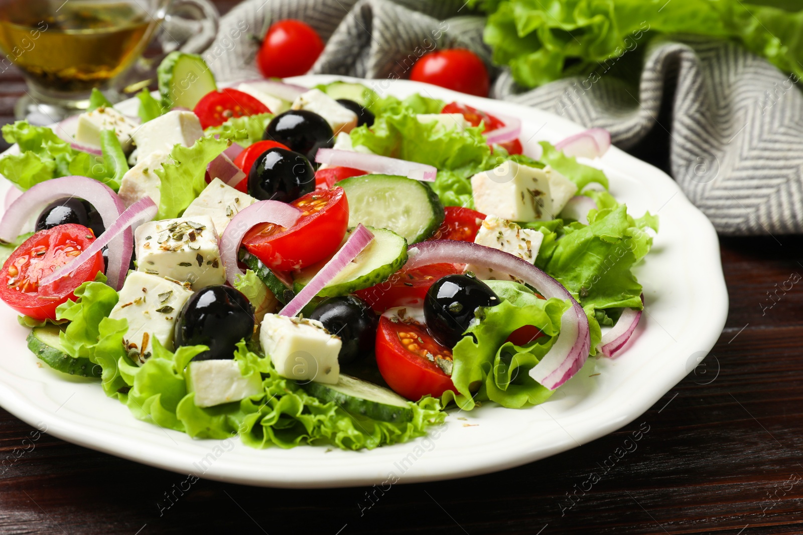 Photo of Delicious salad with feta cheese on wooden table, closeup