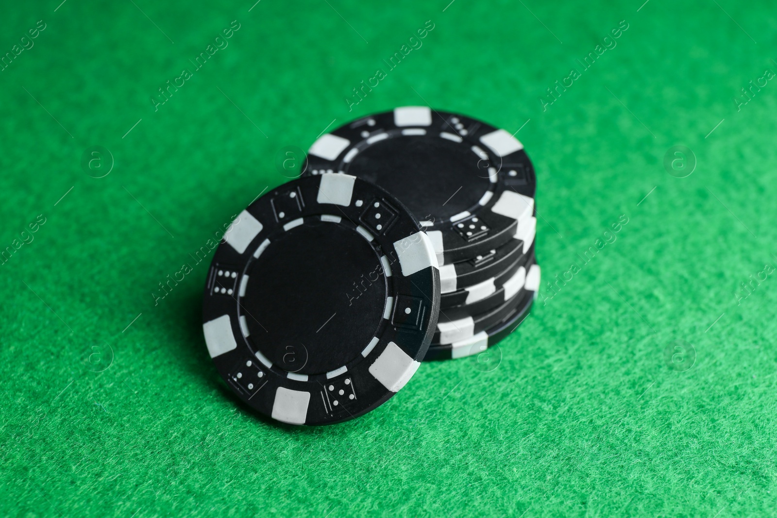 Photo of Poker game. Casino chips on green table