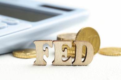 Photo of Word Fed (Federal Reserve System) made with letters and coins on wooden table