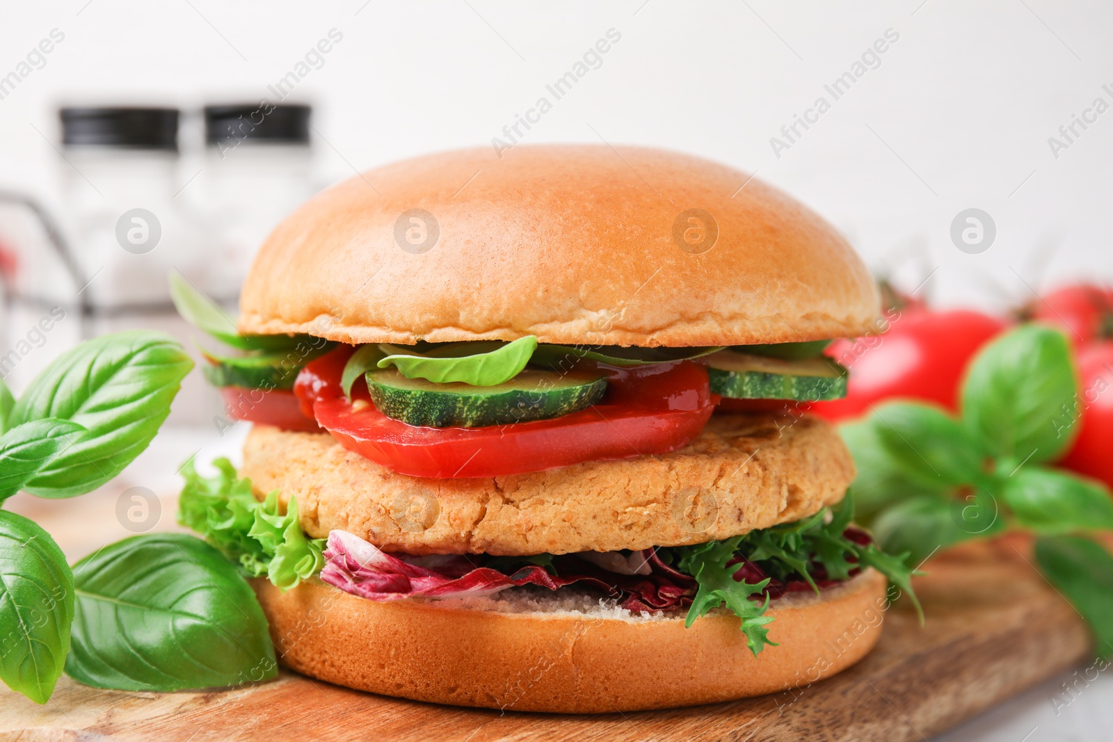 Photo of Delicious vegan burger with chickpea cutlet on table, closeup