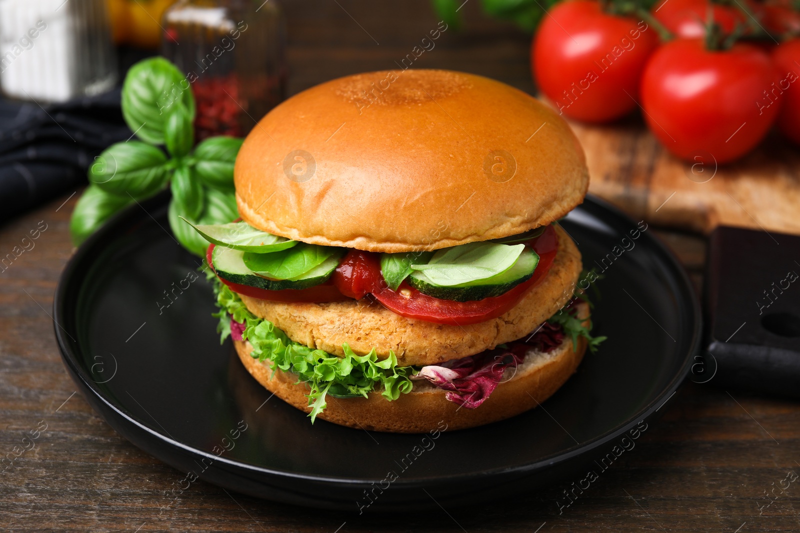 Photo of Delicious vegan burger with chickpea cutlet on wooden table, closeup