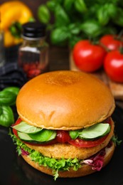 Photo of Delicious vegan burger with chickpea cutlet on table, closeup