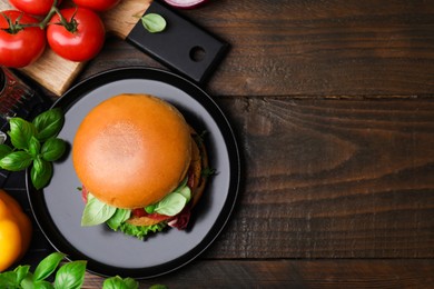 Delicious vegan burger with chickpea cutlet on wooden table, flat lay. Space for text