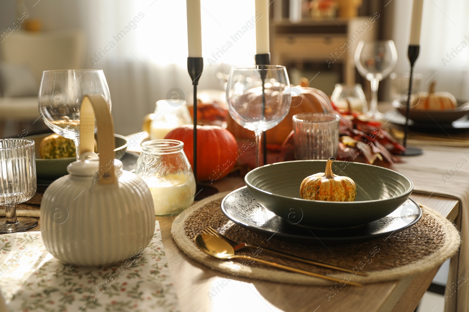 Photo of Stylish table setting with beautiful autumn decor in dining room