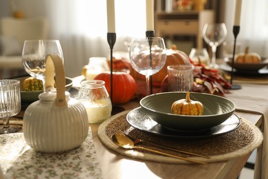 Photo of Stylish table setting with beautiful autumn decor in dining room