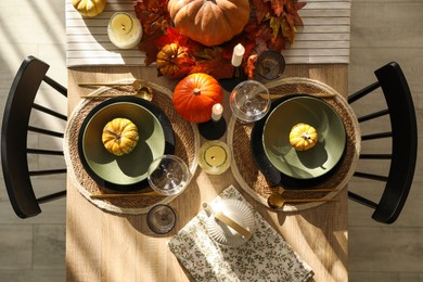 Photo of Stylish table setting with beautiful autumn decor in dining room, top view