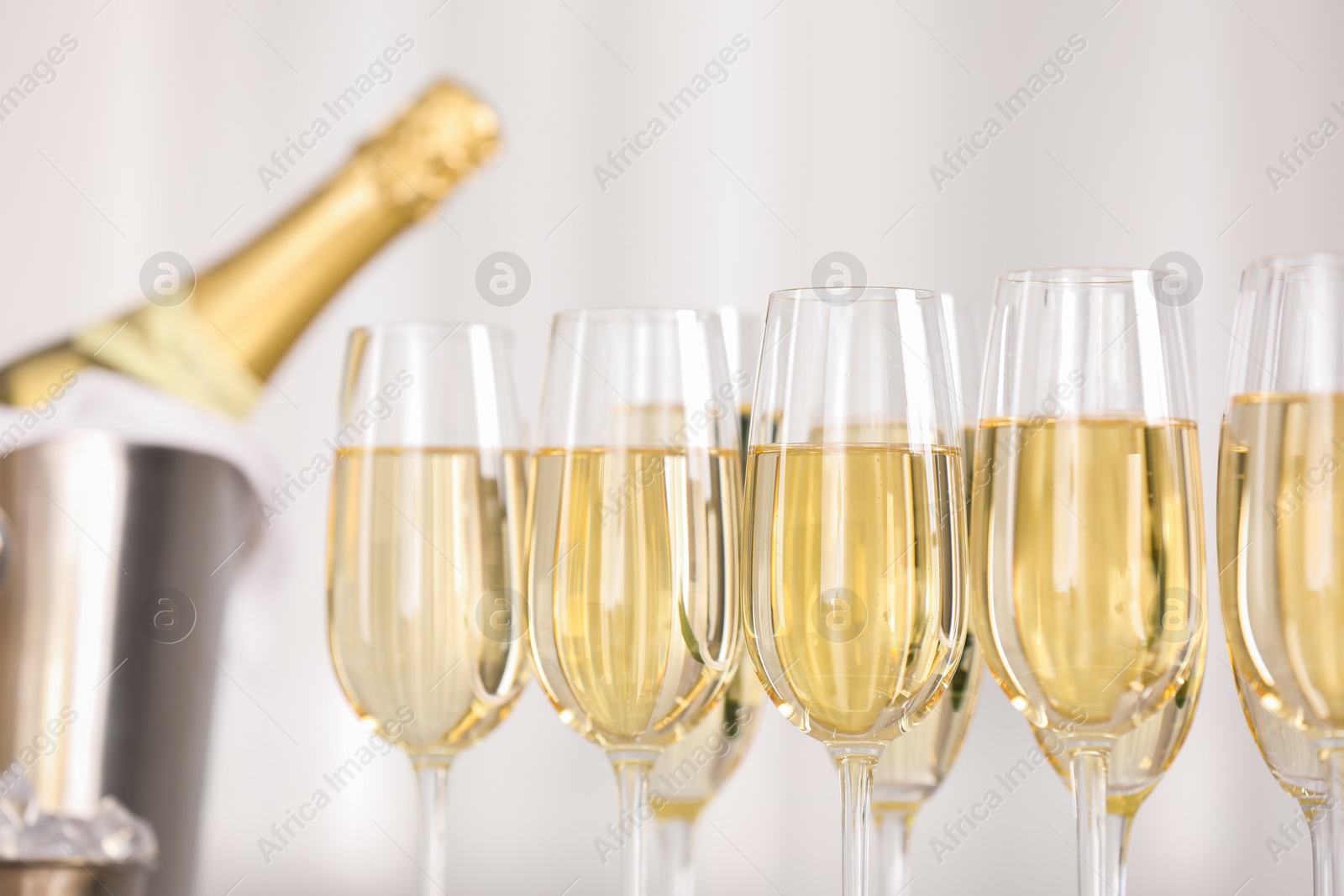 Photo of Champagne in glasses on light background, closeup