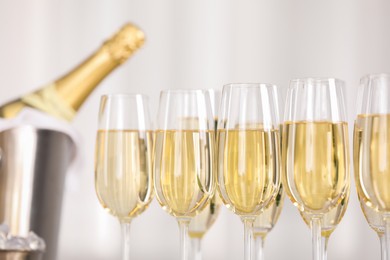 Photo of Champagne in glasses on light background, closeup