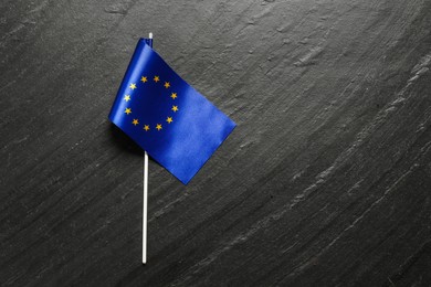 Photo of Flag of European Union on black textured background, top view. Space for text