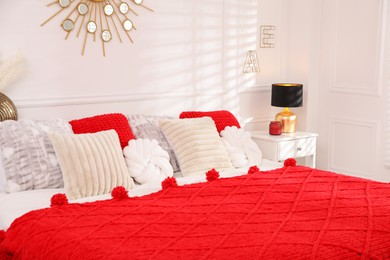 Photo of Big comfortable bed in room. Interior design