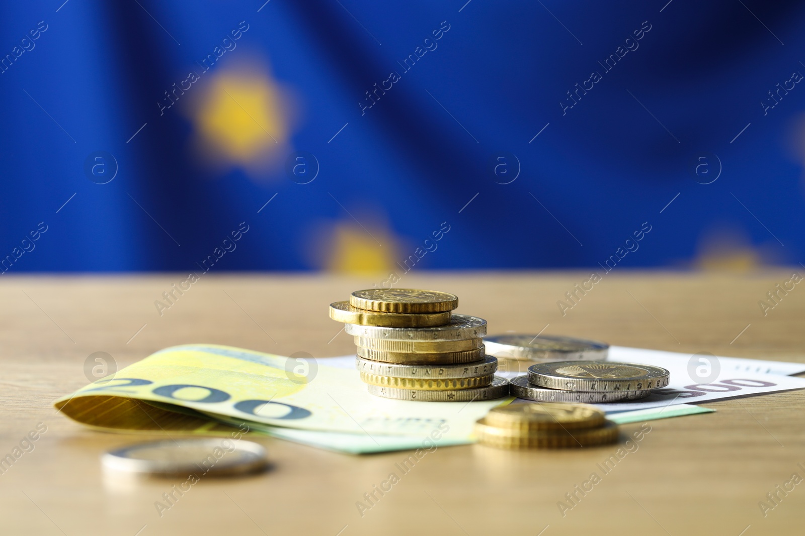 Photo of Euro banknotes and coins on table, closeup