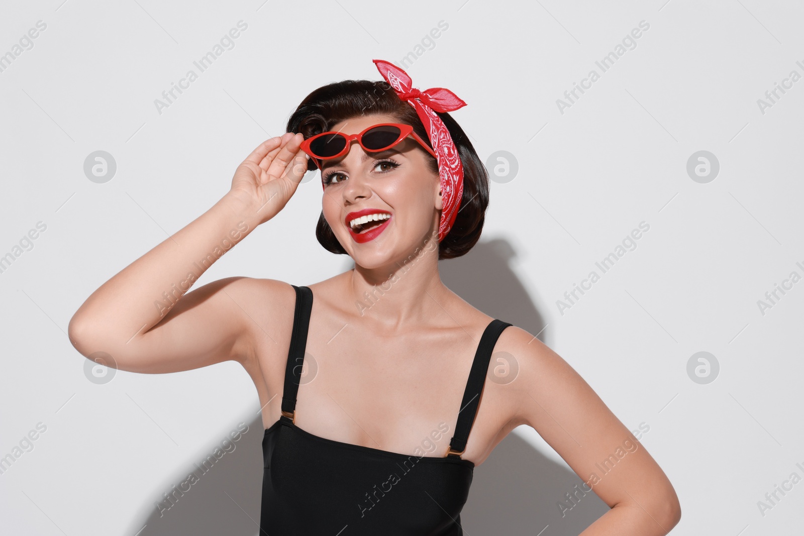 Photo of Portrait of pin-up woman on light background