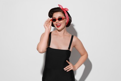 Photo of Portrait of pin-up woman on light background