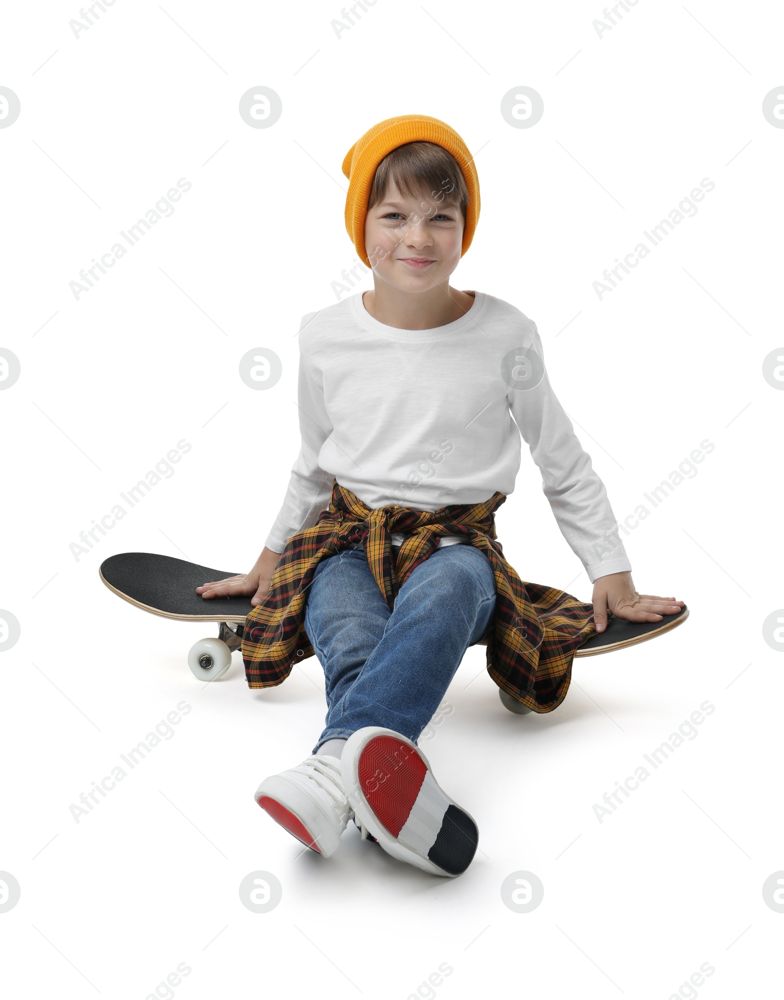 Photo of Little boy with skateboard on white background