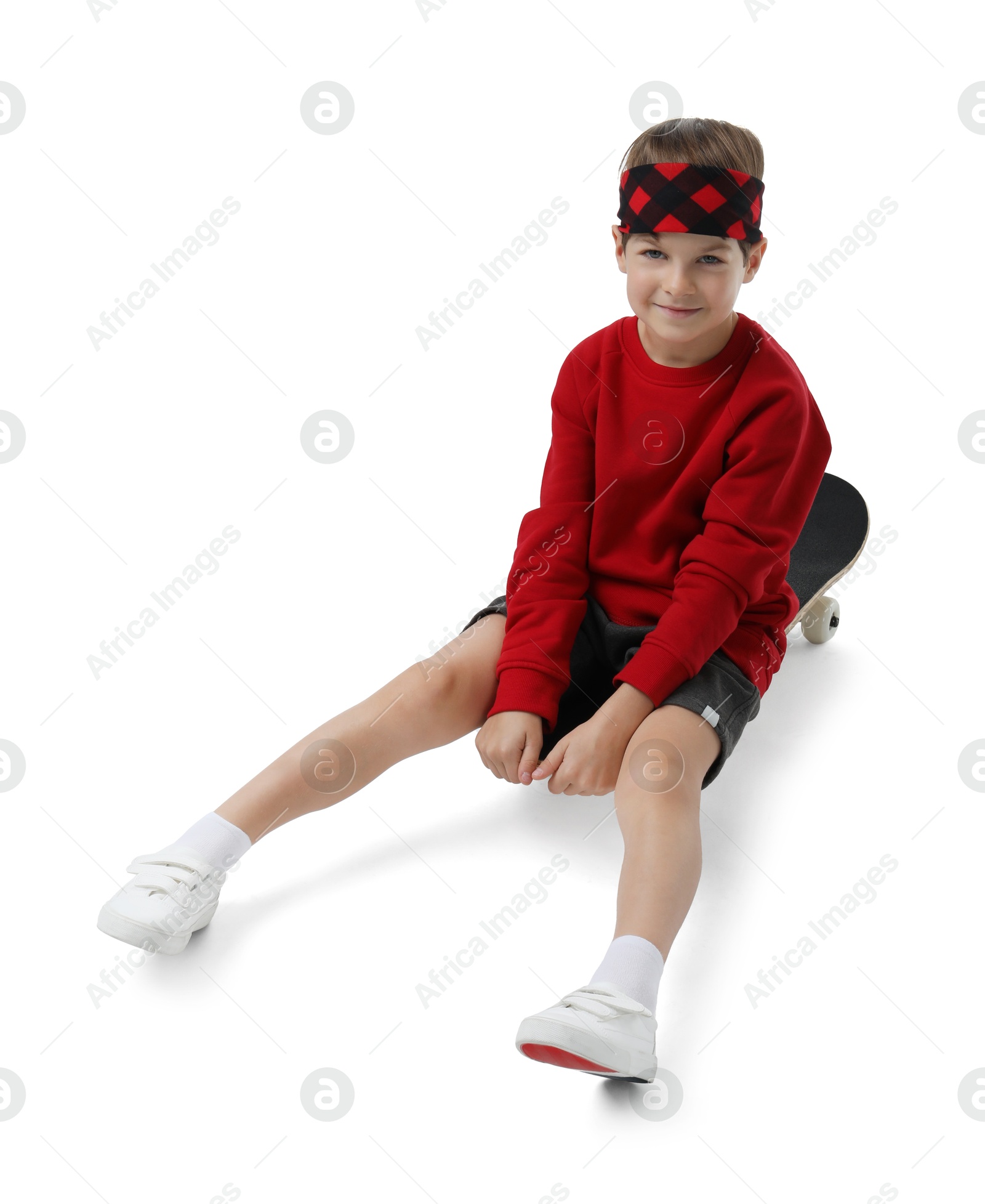 Photo of Little boy with skateboard on white background