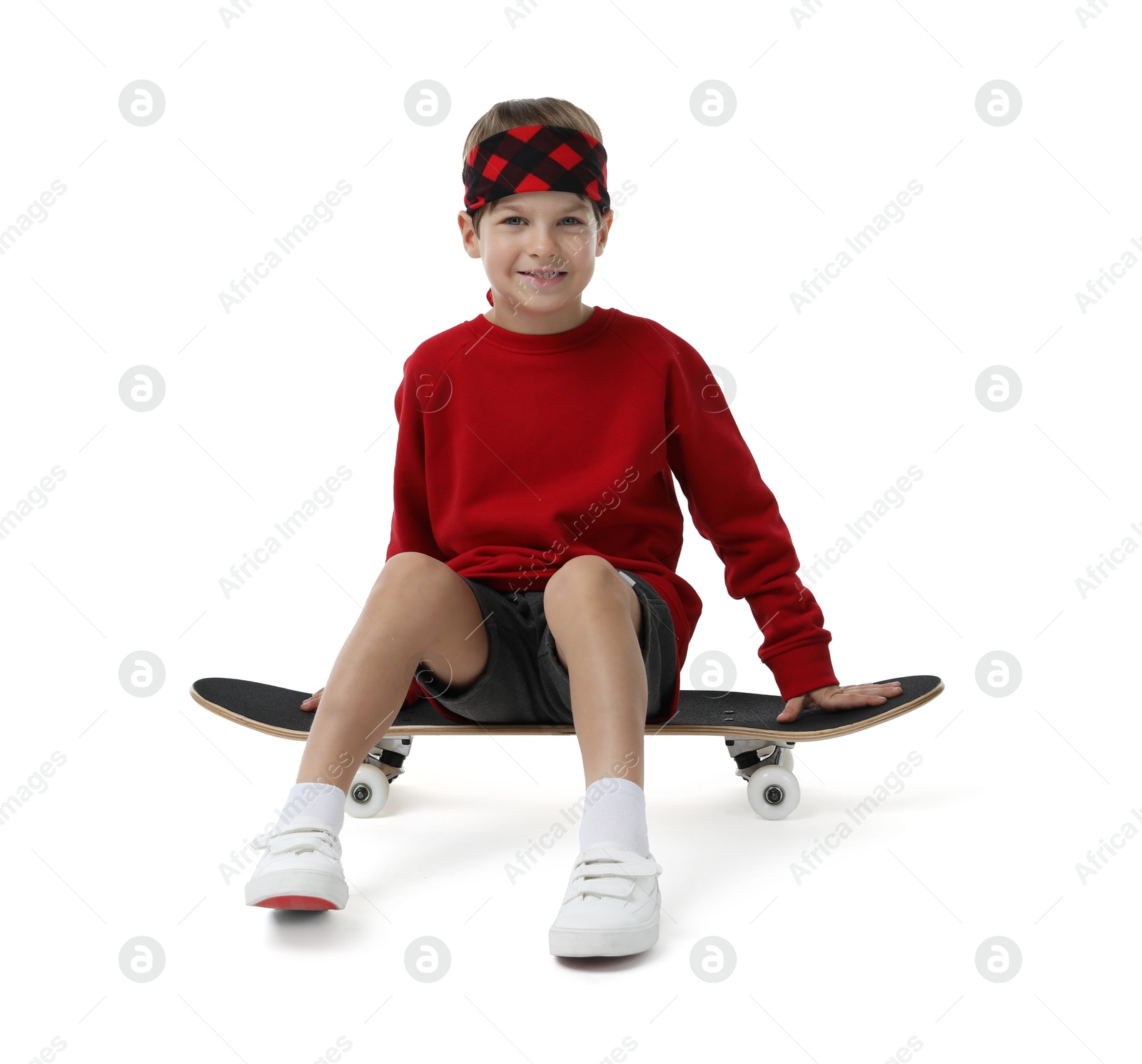 Photo of Little boy with skateboard on white background