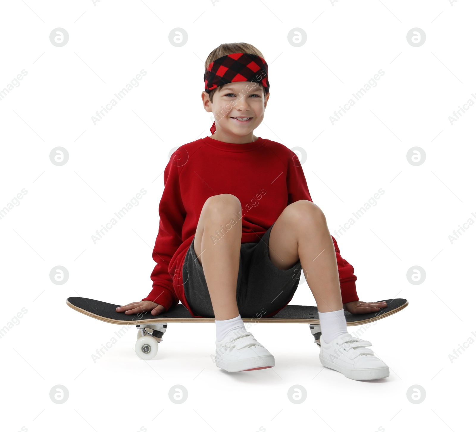 Photo of Little boy with skateboard on white background