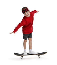 Little boy with skateboard on white background