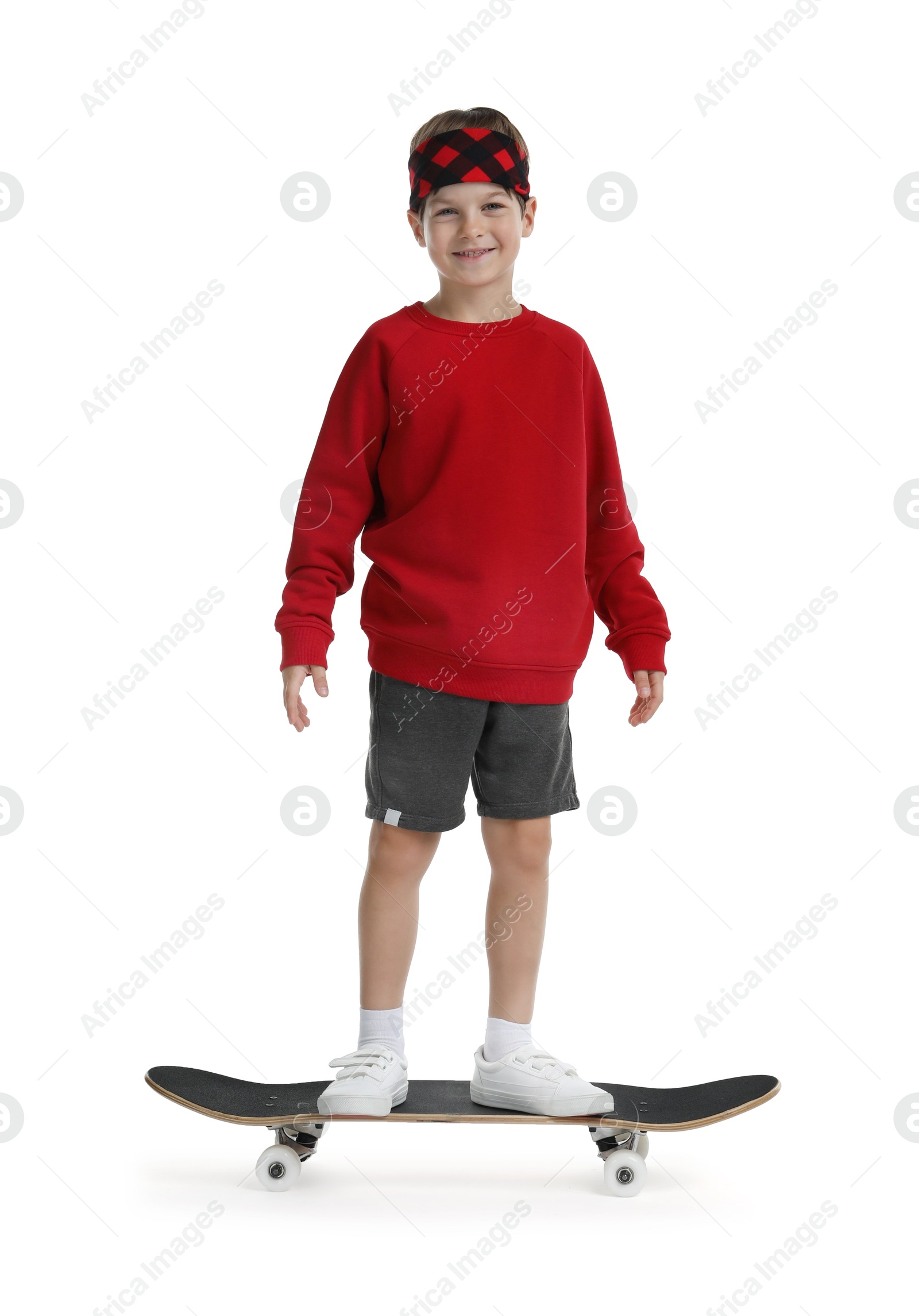 Photo of Little boy with skateboard on white background