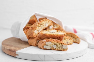 Photo of Traditional Italian almond biscuits (Cantucci) on light table, closeup