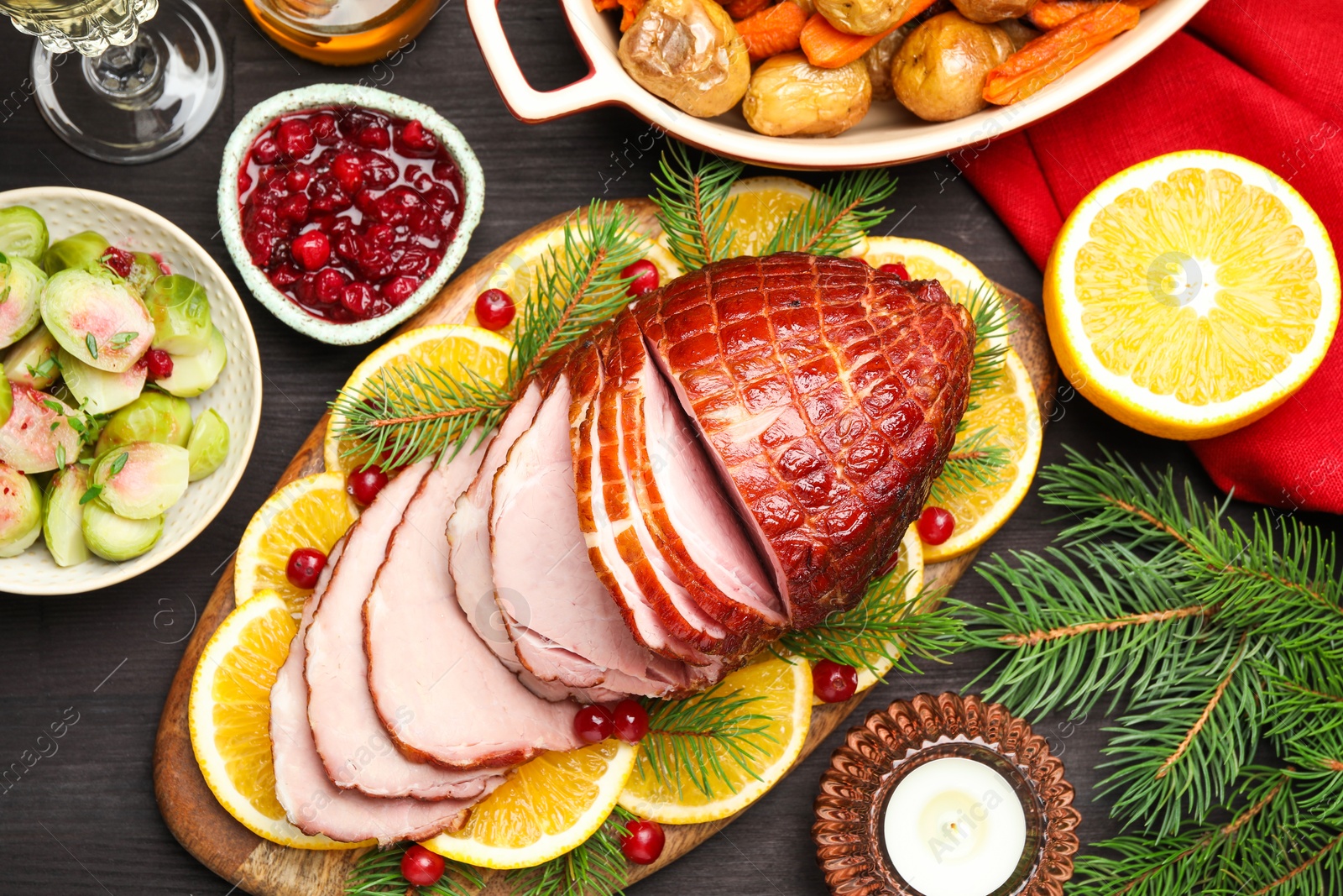 Photo of Tasty baked ham served on black wooden table, flat lay