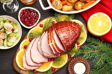 Tasty baked ham served on black wooden table, flat lay