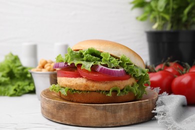 Photo of Delicious vegetarian burger with chickpea cutlet on white table, closeup