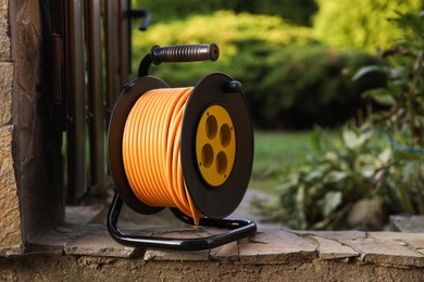 Photo of One extension cord reel outdoors, space for text