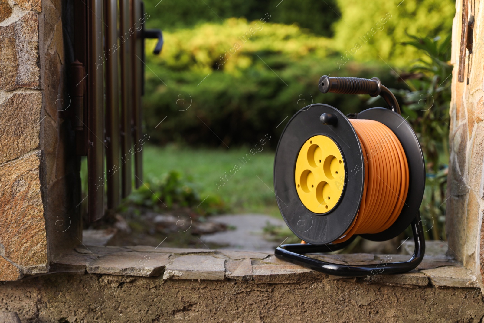 Photo of One extension cord reel outdoors, space for text