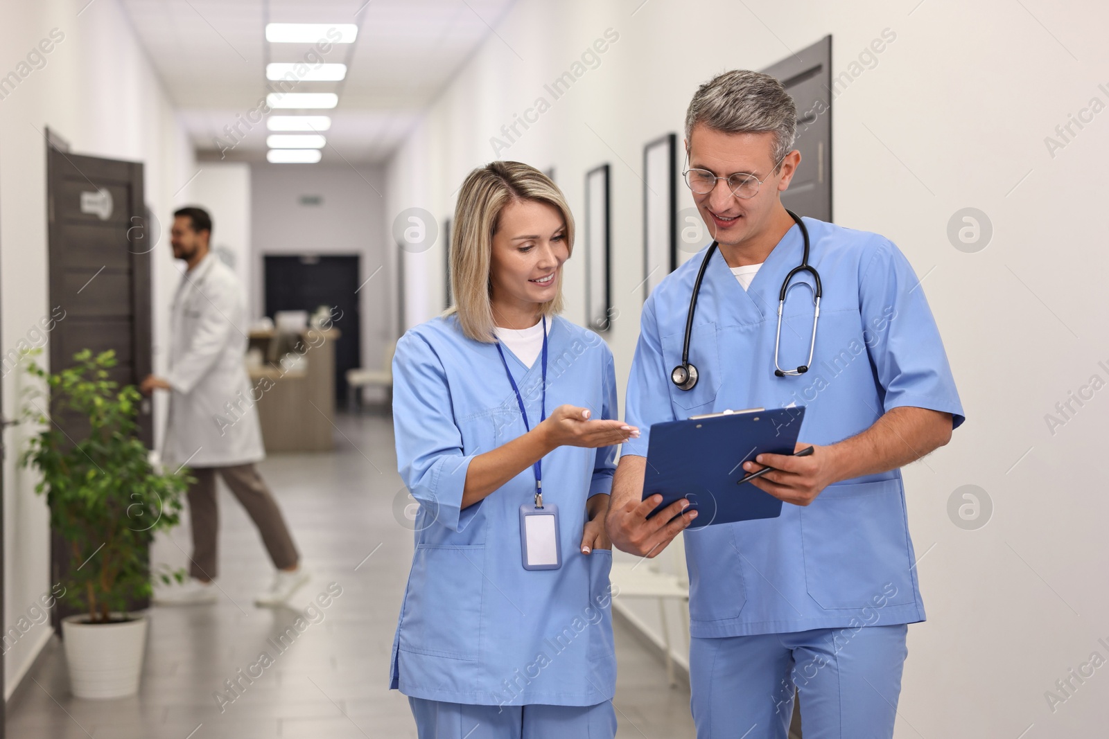 Photo of Healthcare workers with clipboard talking in hospital