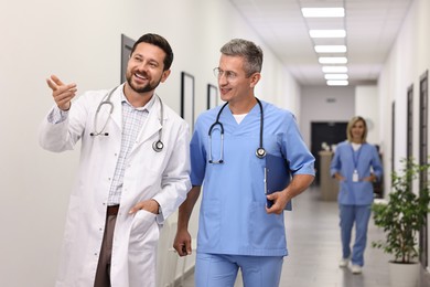 Photo of Healthcare workers talking in hospital. Medical service