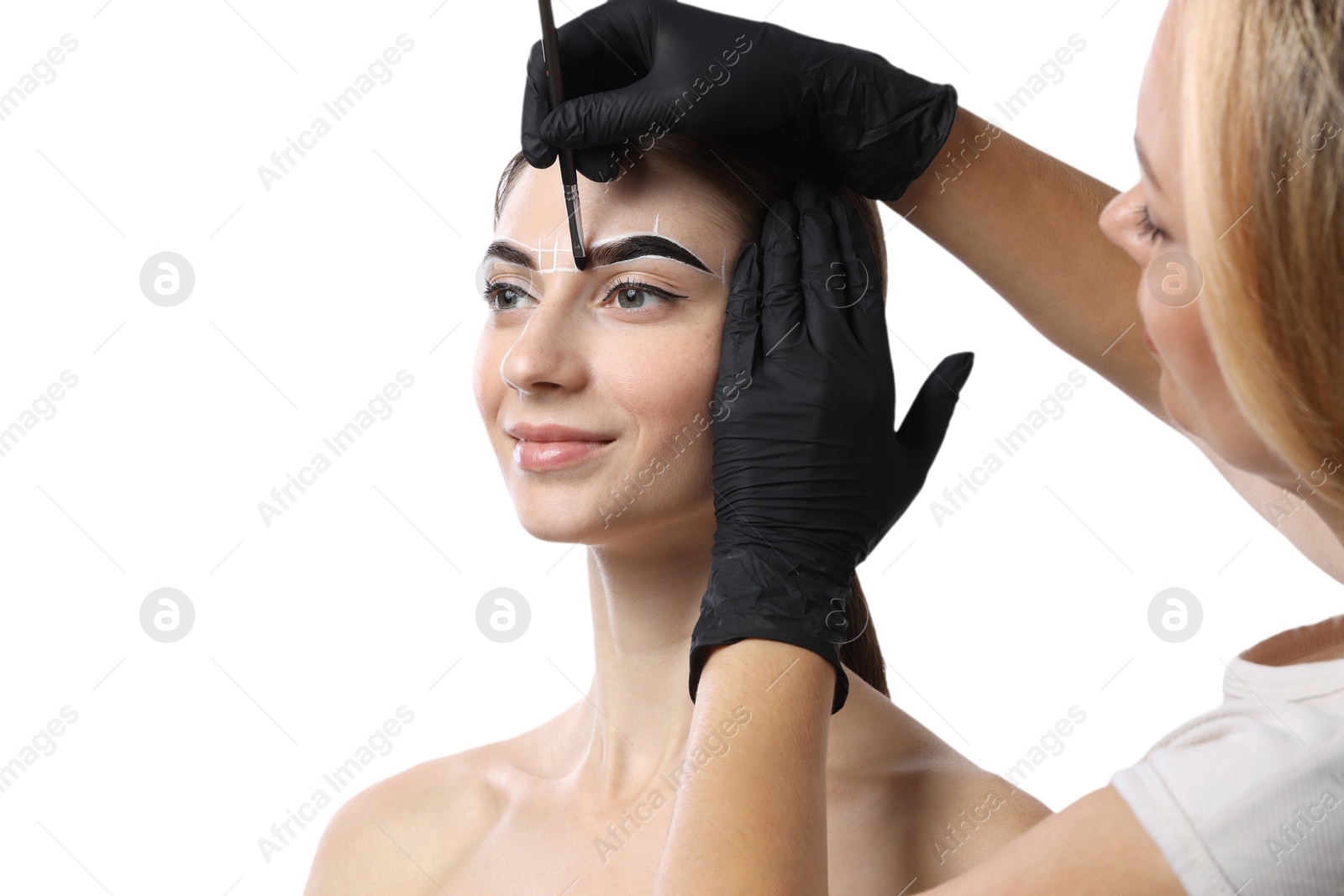 Photo of Young woman undergoing henna eyebrows dyeing procedure on white background