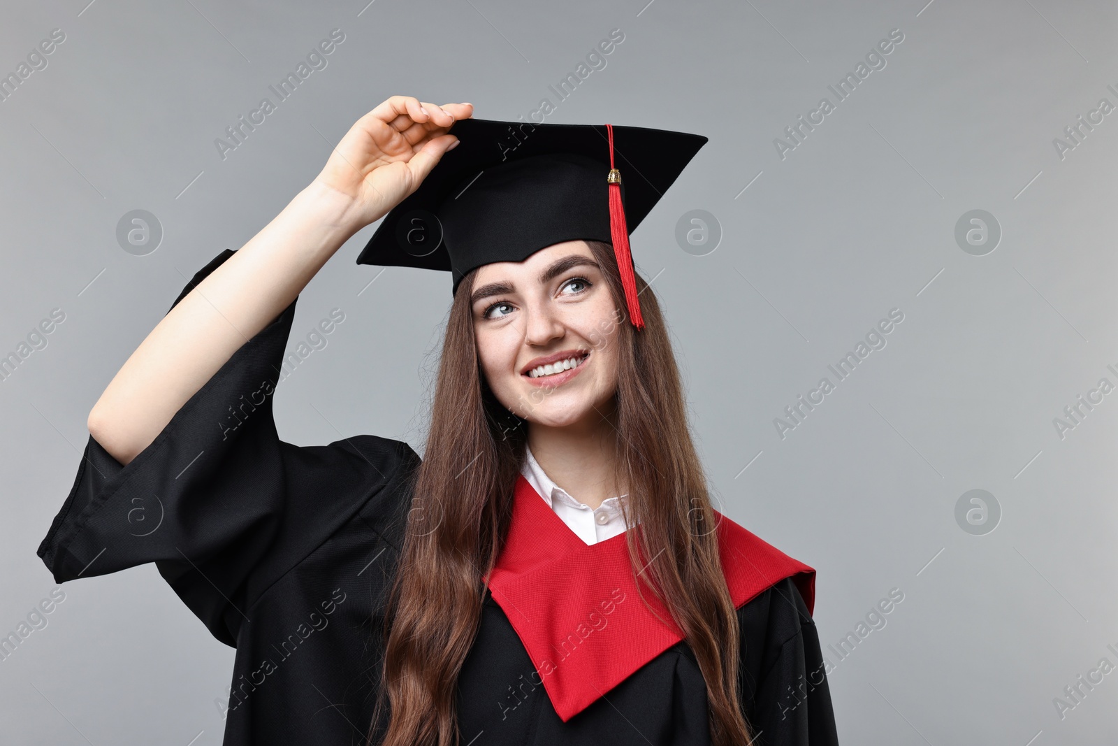 Photo of Happy student after graduation on grey background