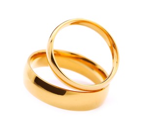 Photo of Beautiful golden wedding rings isolated on white