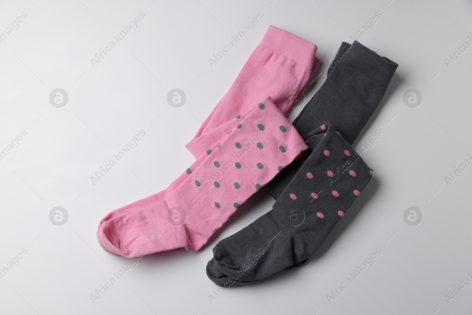 Photo of Different child's tights on white background, top view