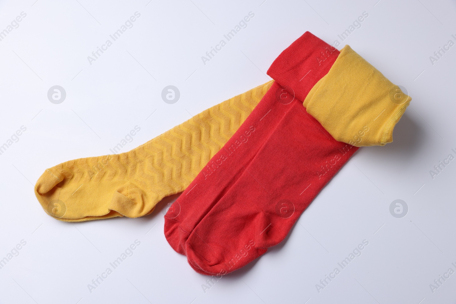 Photo of Different child's tights on white background, top view