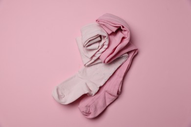 Photo of Beautiful child's tights on pink background, top view