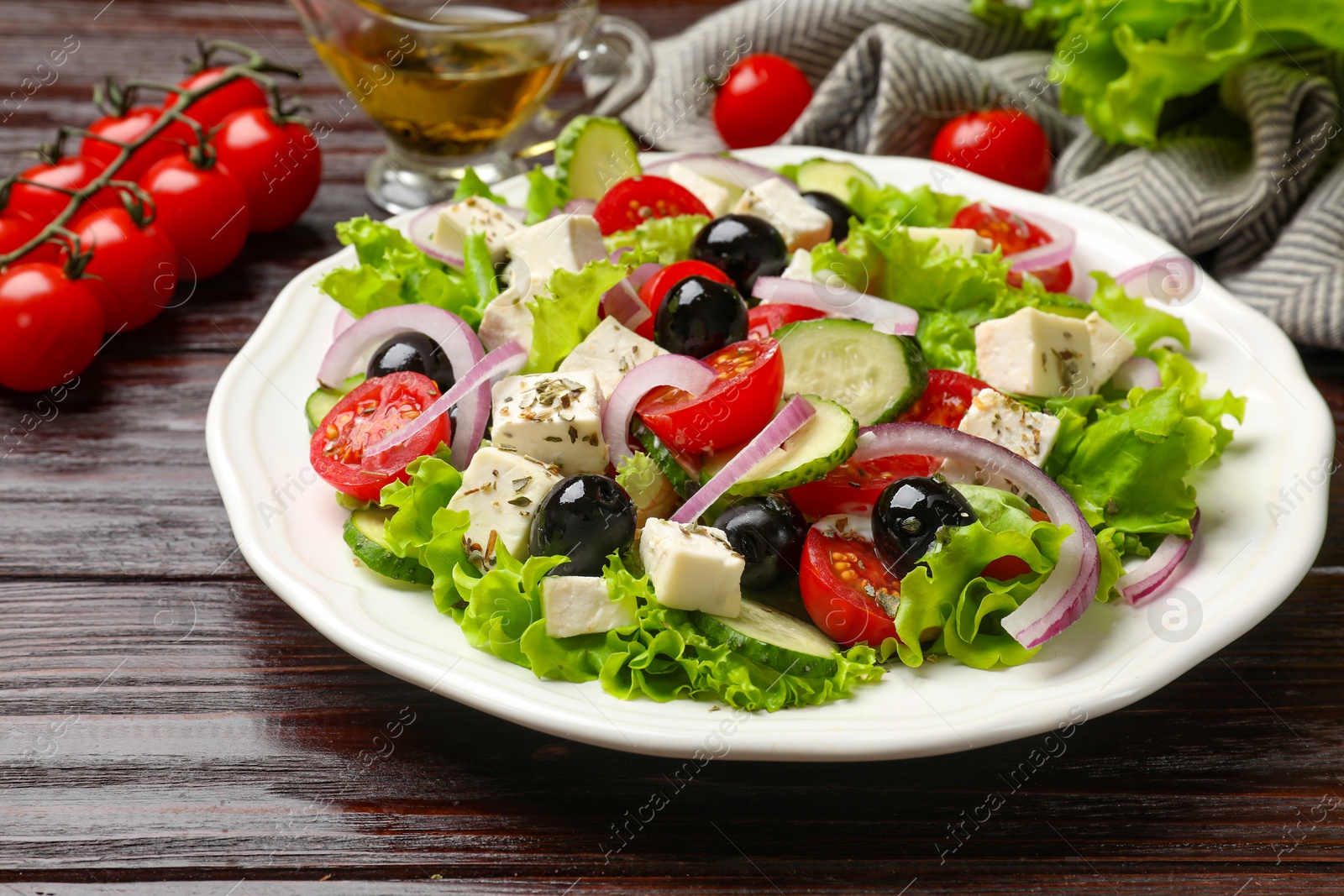 Photo of Delicious salad with feta cheese on wooden table, closeup