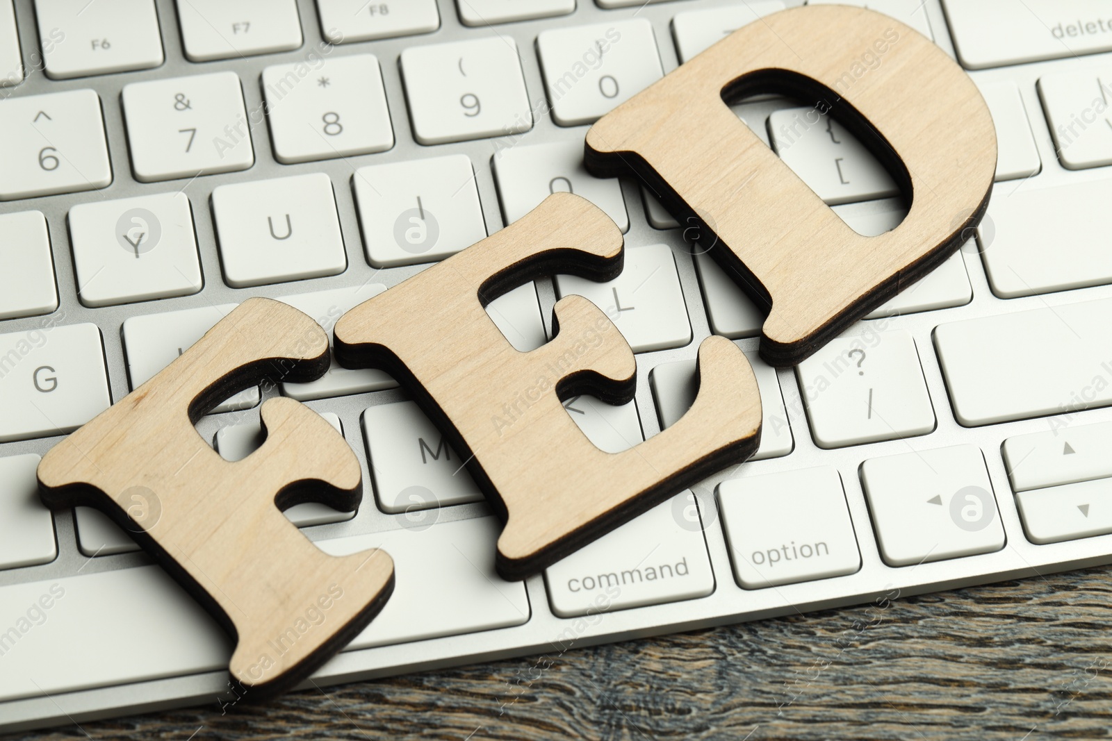 Photo of Word Fed (Federal Reserve System) made with letters and keyboard on wooden table, closeup