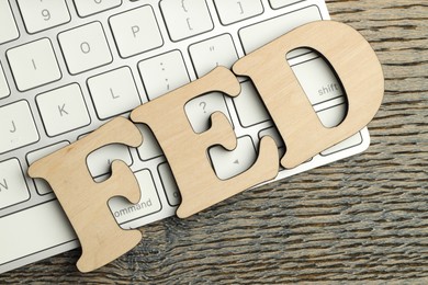 Photo of Word Fed (Federal Reserve System) made with letters and keyboard on wooden table, top view