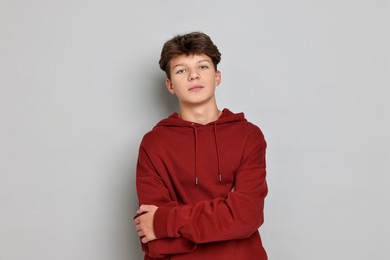 Photo of Portrait of happy teenage boy on light grey background