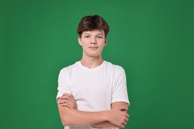 Photo of Portrait of teenage boy on green background