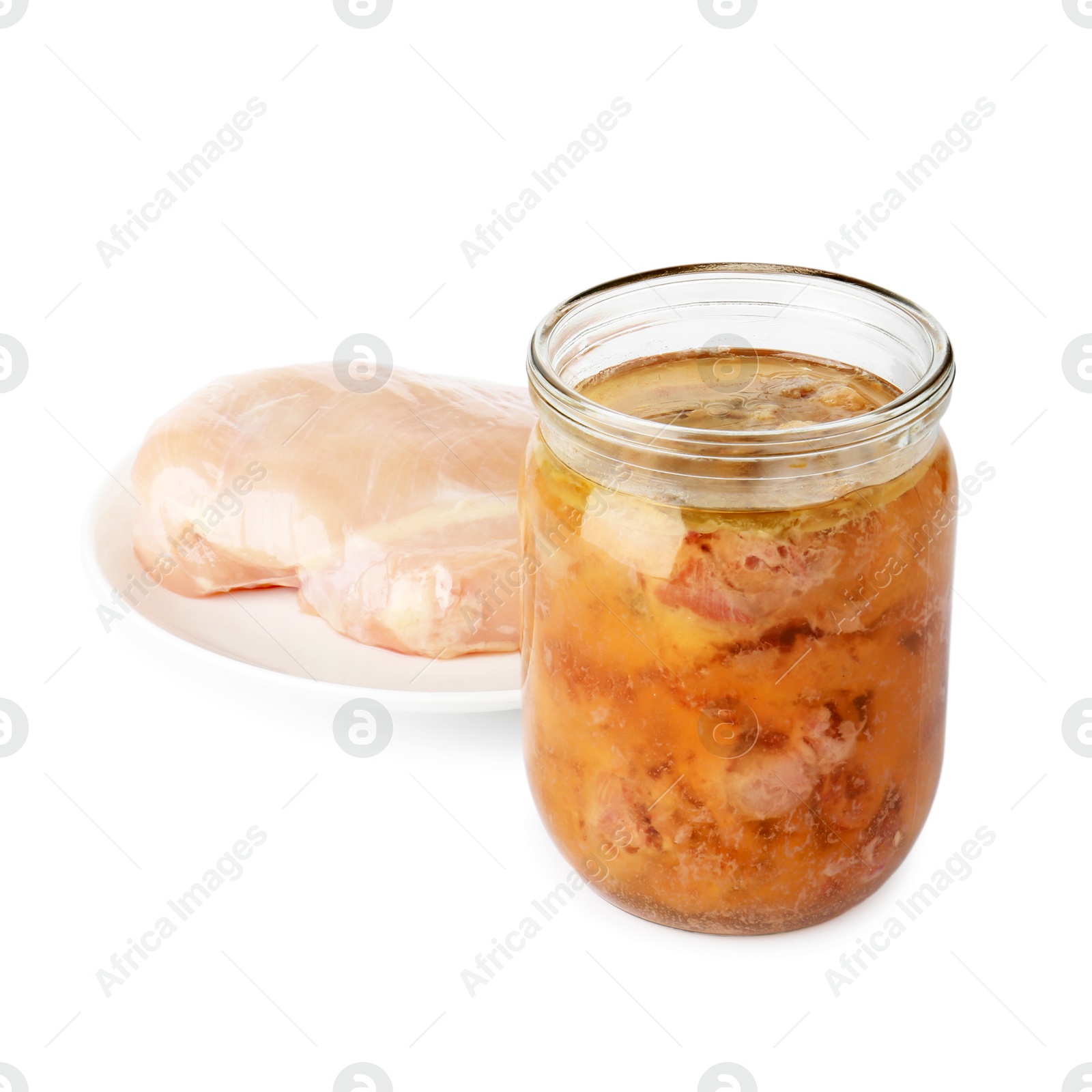 Photo of Canned meat in jar and raw chicken fillet isolated on white