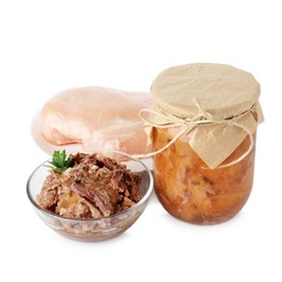 Photo of Canned meat in glass bowl, jar and raw chicken fillet isolated on white