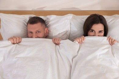 Photo of Lovely couple lying in bed at home