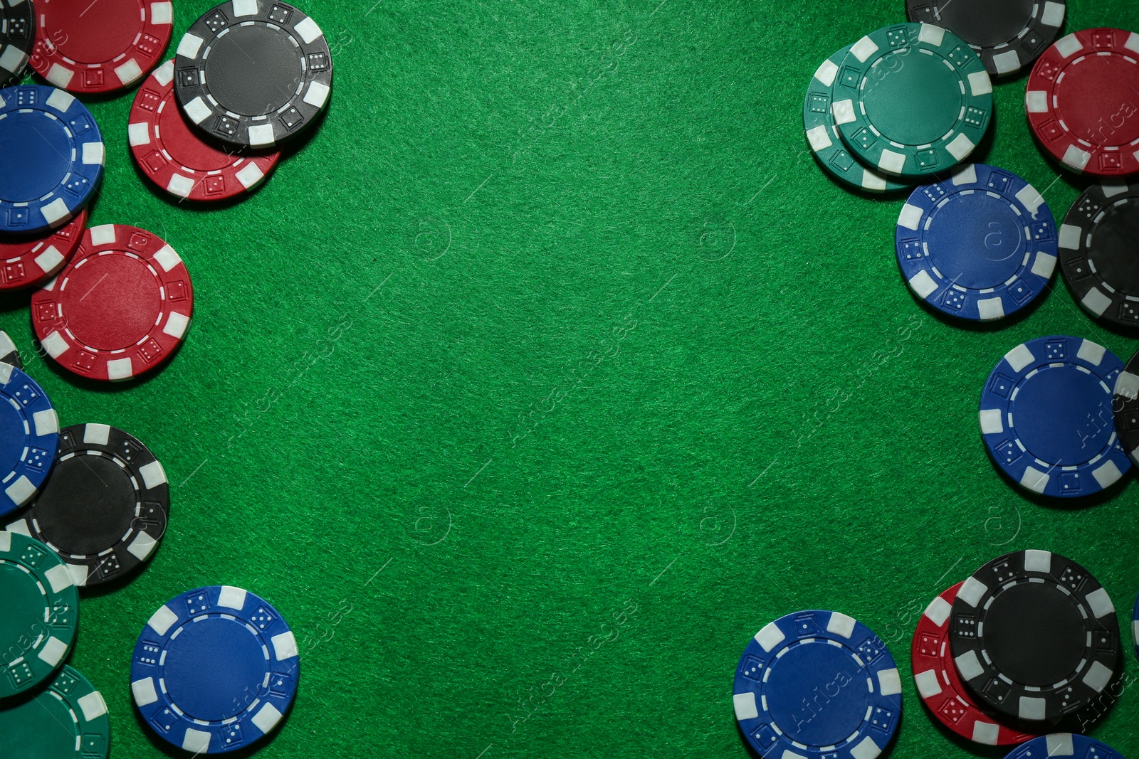 Photo of Frame of poker chips on green table, flat lay. Space for text