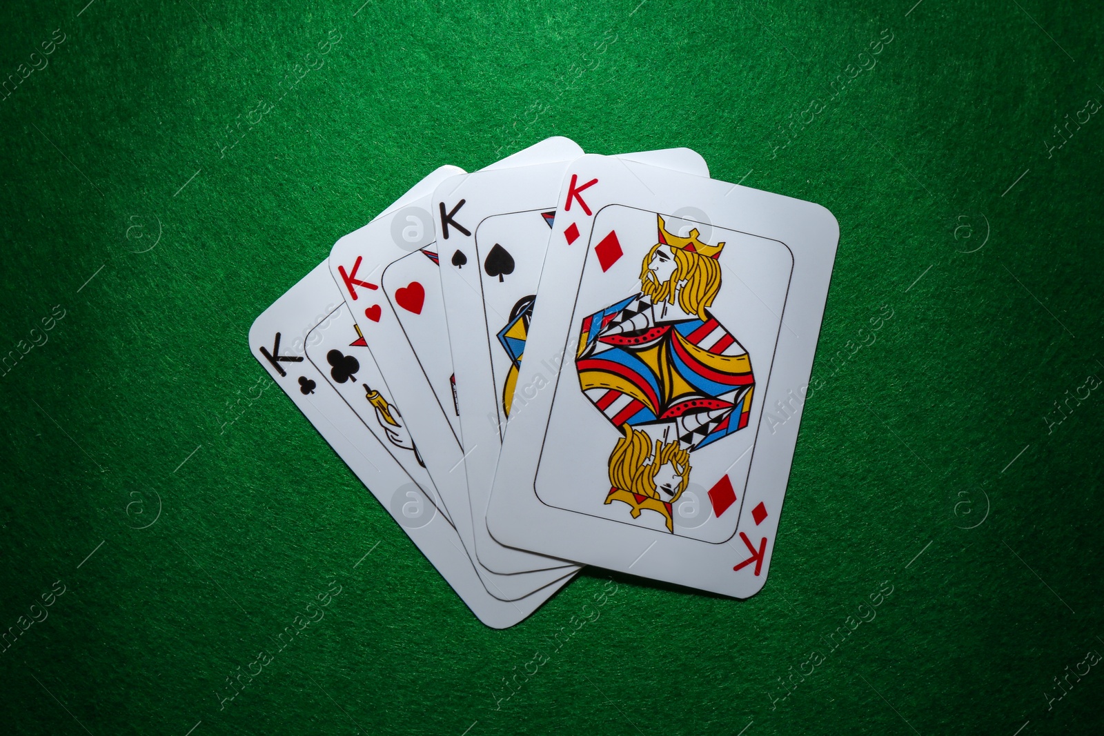 Photo of Poker game. Playing cards on green table, flat lay