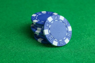 Photo of Group of poker chips on green table, closeup