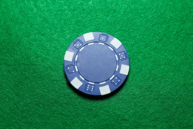 Photo of Poker chip on green table, top view